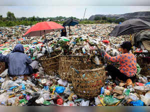 Scavengers collect plastic waste to sell to a recycling centre at a landfill in Medan, North Sumatra on March 27, 2024.
