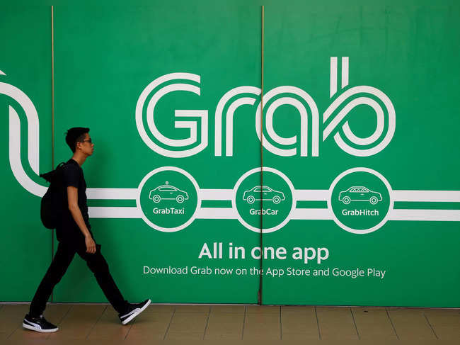 FILE PHOTO: A man walks past a Grab office in Singapore