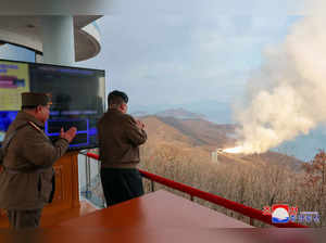 This picture taken on March 19, 2024 and released by North Korea's official Korean Central News Agency (KCNA) via KNS on March 20, 2024 shows North Korea's leader Kim Jong Un (R) observing a ground combustion test of a multi-stage solid fuel engine for a new medium to long range hypersonic missile, at the Sohae Satellite Launch Site in North Phyongan province.