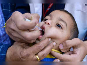 Health workers administer polio vaccine drops to a child during a program to eradicate polio virus in Amritsar on March 3, 2024.