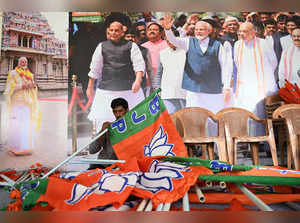 A worker sorts Bharatiya Janata Party (BJP) flags at a BJP election office in Chennai on March 16, 2024, during preparations ahead of the Election Commission India (ECI) schedule announcement India's upcoming general election.