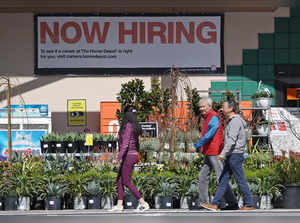 Home Depot customers walk by a posted now hiring sign on March 8, 2024 in San Rafael, California.