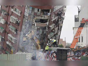 Workers begin demolition of collapsed building, two days after a powerful earthq...