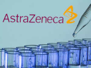 FILE PHOTO_ FILE PHOTO_ Test tubes are seen in front of a displayed AstraZeneca logo in this illustration.
