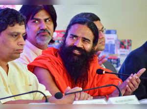 Mumbai: Baba Ramdev and Balkrishna at the announcement of Ruchi Soya Industries ...