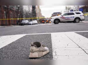 An abandoned shoe is seen in the street at the site of an early morning shooting in the Shaw neighbourhood on March 17, 2024 in Washington, DC. At least two people were killed and five others were injured.