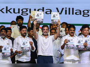 Indian National Congress party leader Rahul Gandhi (C) and Chief Minister of Telangana Revanth Reddy (C, left) along with others hold party's manifesto during an election campaign meeting on the outskirts of Hyderabad on April 6, 2024, ahead of the country's general elections.