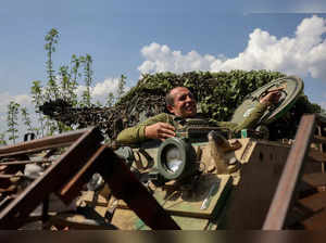 A Ukrainian serviceman rides an M113 armoured personnel carrier on a road in the Donetsk region, on April 12, 2024, amid the Russian invasion of Ukraine.