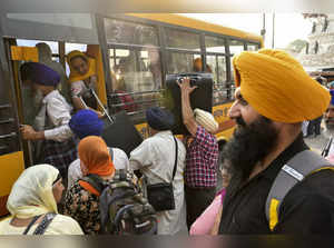 Sikh pilgrims board a bus as they leave for Pakistan to celebrate 'Baisakhi', a spring harvest festival, in Amritsar on April 13, 2024.