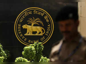 FILE PHOTO: FILE PHOTO: A police officer walks past the Reserve Bank of India (RBI) logo inside its headquarters in Mumbai
