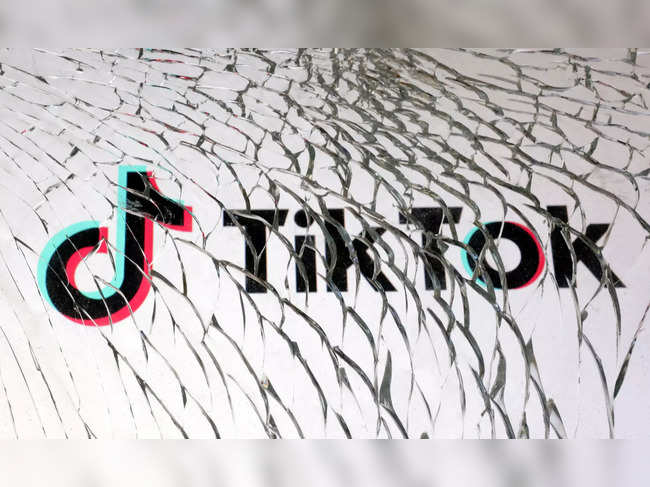 FILE PHOTO: Illustration shows TikTok logo through broken glass