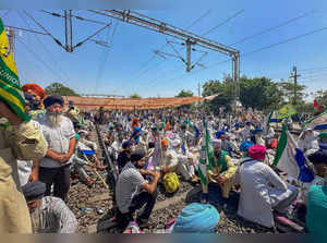 Patiala: Farmers sit on railway tracks during a protest at the Shambhu border, i...