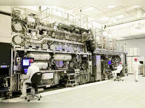 Workers are seen in front of a "High NA EUV" lithography system at an Intel facility in Hillsboro