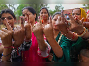 Kathua: Women Voter show their ink marked fingers after casting votes at a polli...