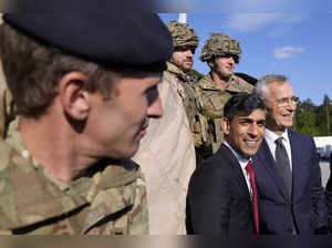 NATO Secretary General Jens Stoltenberg, right, and Britain's Prime Minister Ris...