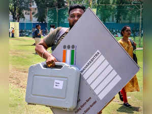 Nagpur: A polling official carries an Electronic Voting Machines (EVM) and other...