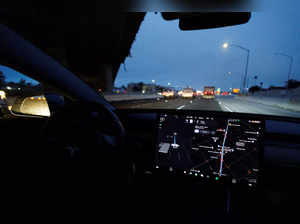 FILE PHOTO: Tesla Model 3 drives on autopilot along California freeway