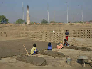 Patna: Labourers work at a brick factory on the  eve of Labour Day, in Patna. (P...