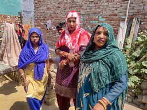 **EDS: TO GO WITH STORY** Hathras: Women of Dalit basti of Pilakhana stand near ...