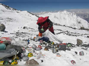 This picture taken on May 23, 2010 shows a Nepalese sherpa collecting garbage, left by climbers, at an altitude of 8,000 metres during the Everest clean-up expedition at Mount Everest.
