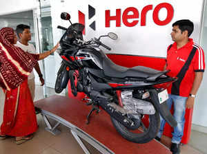 FILE PHOTO_ Customers look at a Hero MotoCorp Karizma motorbike at Hero MotoCorp showroom in Ahmedabad.