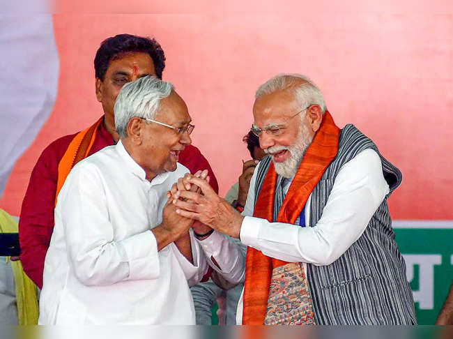 Munger: Prime Minister Narendra Modi with Bihar Chief Minister Nitish Kumar duri...