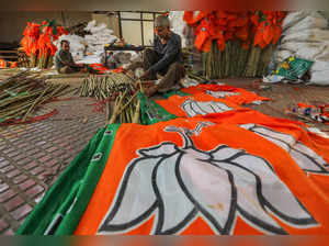 Jammu: Workers arrange BJP flags ahead of the Lok Sabha elections, at the party ...