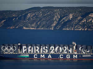 The CMA CGM Greenland container ship is seen at sea with Paris 2024 and the Olympic rings on it during the Olympics torch relay ahead Paris 2024 Olympic games