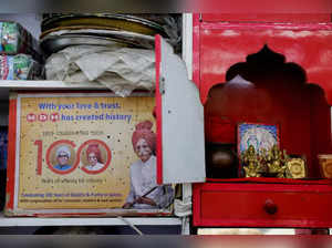 FILE PHOTO: A carton displaying the Indian spice manufacturing company MDH's centenary celebration is placed next to a home temple at a shop in the old quarters of Delhi