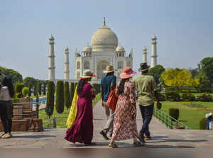 Agra: Tourists at the Taj Mahal on a hot summer day, in Agra. (PTI Photo) (...