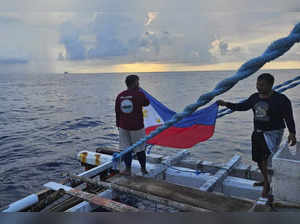 Filipino activists decide not to sail closer to disputed shoal, avoiding clash with Chinese ships