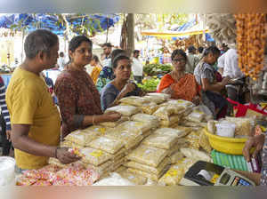 Bengaluru: People buy snacks and sweets ahead of the Makar Sankranti festival, i...