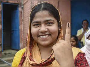 Saran: A woman shows her inked finger after casting her vote during the fifth ph...