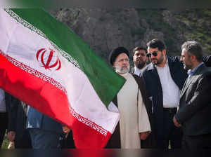 A handout picture provided by the Iranian presidency shows Iran's President Ebrahim Raisi (C) at the site of Qiz Qalasi, the third dam jointly built by Iran and Azerbaijan on the Aras River, ahead of its inauguration ceremony on May 19, 2024.