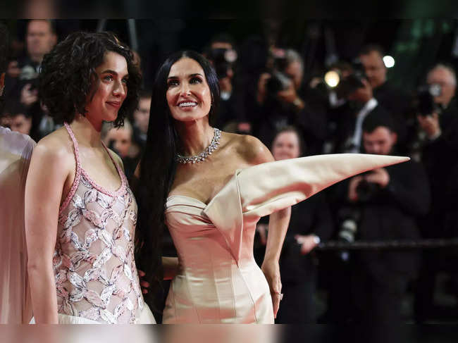 US actress Demi Moore (R) and US actress Margaret Qualley arrive for the screening of the film "The Substance" at the 77th edition of the Cannes Film Festival in Cannes, southern France, on May 19, 2024.