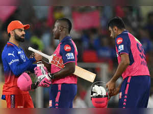 Royal Challengers Bengaluru's Virat Kohli (L) greets Rajasthan Royals' Rovman Powell (C) after their win in the Indian Premier League (IPL) Twenty20 eliminator cricket match between Royal Challengers Bengaluru and Rajasthan Royals at the Narendra Modi Stadium in Ahmedabad on May 22, 2024.