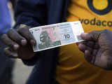 Zimbabwe authorities mix charm with force in an attempt to shore up the world's newest currency