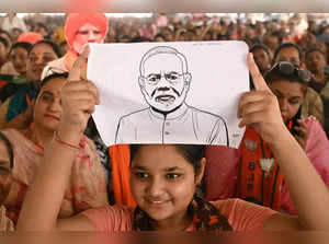 A supporter holds a sketch of India's Prime Minister and leader of the ruling Bharatiya Janata Party (BJP) Narendra Modi during an election campaign rally in Gurdaspur on May 24, 2024, amid the country's ongoing general election.