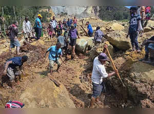Villagers search through a landslide in Pogera village, in the Highlands of Papu...