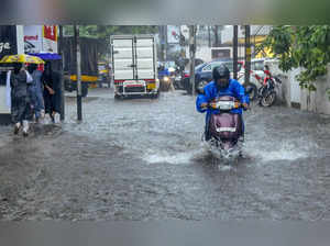 Kochi: Vehicles move on a flooded road during rain, in Kochi. (PTI Photo)(...