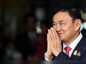 Former Thai Prime Minister Thaksin Shinawatra greets his supporters after landing at Bangkok's Don Mueang airport on August 22, 2023.