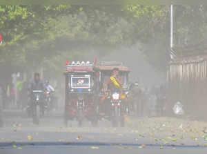 Prayagraj, Apr 25 (ANI): Commuters travel amid a dust storm during a hot summer ...