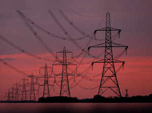 FILE PHOTO: The sun rises behind electricity pylons near Chester