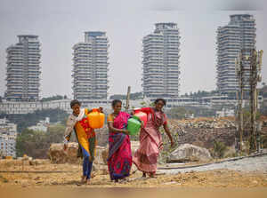 Bengaluru: Women carry water pots amid the ongoing water crisis, in Bengaluru. (...