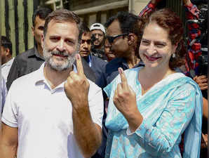 New Delhi: Congress leaders Rahul Gandhi and Priyanka Gandhi show their inked fi...