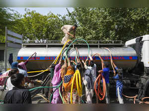 New Delhi: Residents fill water from a tanker amid water crisis, at the Vivekana...