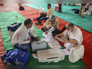 Polling officials check Electronic Voting Machine (EVM) and other voting materials at a distribution centre in Varanasi on May 31, 2024, on the eve of the seventh and final phase of voting in India's general election.