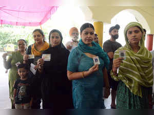 Jalandhar, June 01 (ANI): Voters show their voter cards as they wait in a queue ...