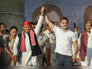 Indian National Congress (INC) Party leader Rahul Gandhi (2R) and Samajwadi Party President Akhilesh Yadav (C) gesture as they arrive to attend an election rally of Indian National Developmental Inclusive Alliance (INDIA) on the outskirts of Varanasi on May 28, 2024, during country's ongoing general election.