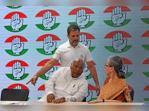 India’s Congress party leader Rahul Gandhi (C top) gestures to his mother Sonia Gandhi (R) as party president Mallikarjun Kharge watches before addressing a press conference at the party headquarters in New Delhi on June 4, 2024.